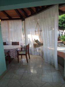 un patio con mesa, sillas y hamaca en Villa Verde Apartments and Rooms, en Premantura