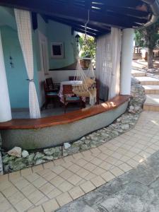 a porch of a house with a swing at Villa Verde Apartments and Rooms in Premantura