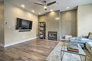 a living room with a fireplace and a tv at 2 Mi to National Mall Modern DC Retreat with Patio in Washington