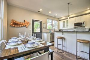 a kitchen with a table with chairs and a dining room at Modern D C Retreat with Private Outdoor Space! in Washington