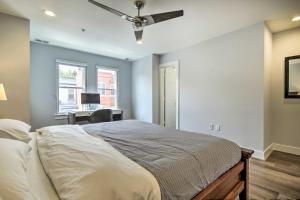a bedroom with a bed with a ceiling fan at 2 Mi to National Mall Modern DC Retreat with Patio in Washington