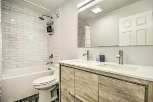 a bathroom with a sink and a toilet and a tub at 2 Mi to National Mall Modern DC Retreat with Patio in Washington +23 photos