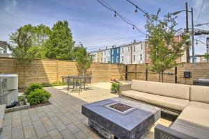 a patio with a couch and a table in a backyard at 2 Mi to National Mall Modern DC Retreat with Patio in Washington
