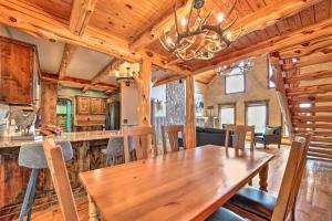 a dining room and kitchen with a wooden table and chairs at Eureka Springs Area Cabin with Deck and 7 Acres! in Golden