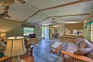 a living room with a couch and a table at Secluded Woodsy Cabin Hike, Fish, Hunt and ATV! in Arkdale