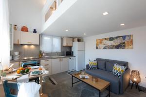 a kitchen and living room with a couch and a table at The Be House in Sifnos