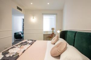 a bedroom with a bed and a green couch at La Terrazza Antica Dimora in Campobasso