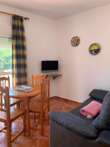 A television and/or entertainment centre at Apartamentos Carolina Még 8 kép