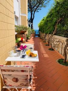 a table with a plate of food on a patio at L'Angolo di Felicia in Nerano