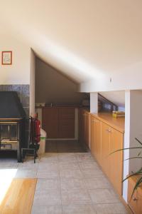 a large kitchen with wooden cabinets and a stove at Nette in Pärnu