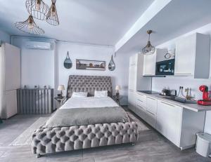 a bedroom with a large bed and white cabinets at Mamaia Luxury Studio Apartment T in Mamaia