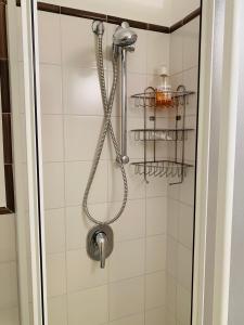 a shower with a shower head in a bathroom at L'Angolo di Felicia in Nerano