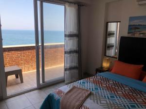 a bedroom with a bed and a view of the ocean at Bahamas Beachfront Break in Alexandria