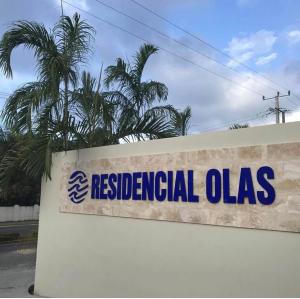 a sign for residential olas on the side of a building at Furnished Apartment - Residencial Olas - Gated Community - 24 hr Security in San Felipe de Puerto Plata