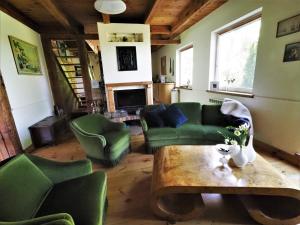 a living room with green furniture and a coffee table at Pod Lipami in Zawady