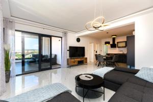 a living room with a couch and a table at Apartments Villa Casia in Srima