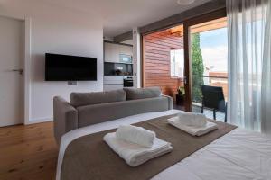 a living room with a large bed and a couch at Vivienda El Ciprés. Terraza con espectaculares vistas al Mar. in Garachico