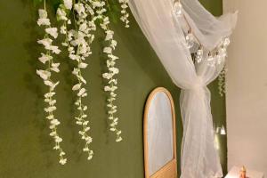 a room with a mirror and a curtain and flowers at Boho Chic Beach Resort in Sardegna in Porto Istana