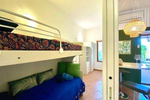 a bedroom with a bunk bed and a kitchen at Boho Chic Beach Resort in Sardegna in Porto Istana +36 photos