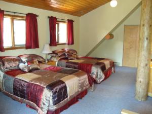 A bed or beds in a room at Helmcken Falls Lodge Cabin Rooms and RV Park