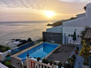 a view of the ocean from a house with a swimming pool at Cactus Guest House in Cidade Velha