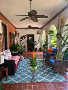 a living room with couches and a ceiling fan at Design District Retreat in Miami