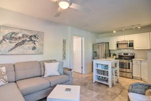 a living room with a couch and a kitchen at Apartment with Easy Access to Indian Rocks Beach! in Clearwater Beach