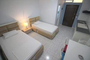 Postel nebo postele na pokoji v ubytování Murati Suites Sarandë