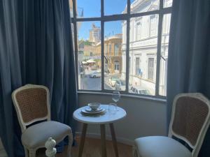 a table and chairs in a room with a window at Unique Studios Phaneromenis 41 - Down Town Nicosia in Nicosia