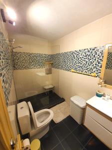 a bathroom with a toilet and a sink at Comporta Family House in Comporta