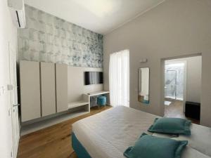 a bedroom with a large bed with green pillows at L’ULIVO in Taranto