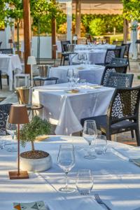 a row of tables with wine glasses on them at Boutique Hotel Casa Mariantonia in Anacapri