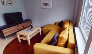 salon z kanapą i stołem w obiekcie Top Sea Apartament 1 w Gdańsku