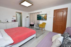 a bedroom with a large bed and a kitchen at Suite Golan in Neot Golan