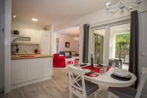 a kitchen and living room with a table and chairs at Holiday Home 4542 in Mali Ston