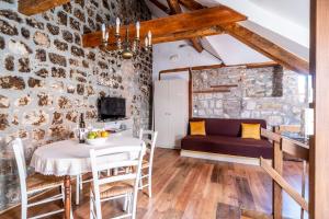 a dining room with a table and a couch at Apartments Martecchini in Dubrovnik