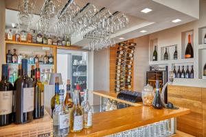 a bar with bottles of wine and wine glasses at Boutique Hotel Casa Mariantonia in Anacapri