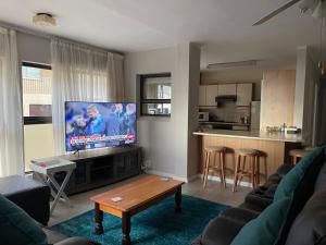 A television and/or entertainment centre at Jackie’s 3 bedroomed secure beach front apartment Strand Golden Mile 