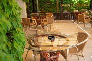 a glass table and chairs in a patio at Hotel Dana Resort in Venus