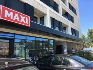 a mayx building with a car parked in front of it at Duki New Belgrade in Belgrade