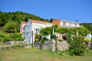 a house on top of a stone wall at One bedroom apartment 3558-5 in Žuljana