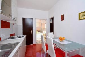 a kitchen with a table with a bowl of fruit on it at One bedroom apartment 3558-5 in Žuljana