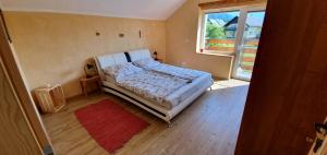 a small bedroom with a bed and a window at Tree in Bled