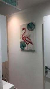 a painting of a pink flamingo on a wall at IL TURCHESE in Cagliari
