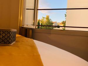 a room with a window and a table with a view at Duplex Bellevue SPA PRIVATIF Toit d'Aix in Aix-en-Provence +86 photos