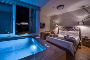 a bedroom with a bed and a swimming pool at A.P. Acropolis View Apartments in Athens