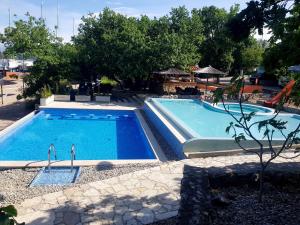 a large swimming pool in a yard with at Krk Mobile Homes in Klimno