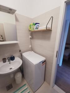 a small bathroom with a toilet and a sink at Apartmani Kronjac in Milna