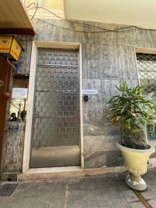 a glass door with a potted plant in front of a building at Unique Studios Phaneromenis 41 - Down Town Nicosia in Nicosia