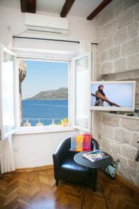 a living room with a large window with a view of the ocean at Kanavelic place - Old town Korcula in Korčula